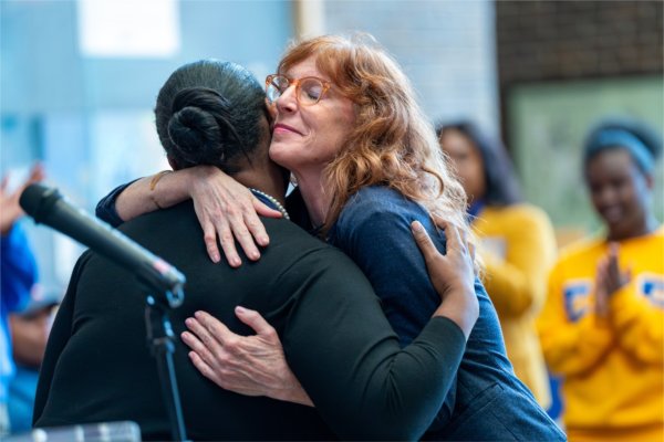 Melissa Baker-Boosamra, hugs Tania Belcher after Belcher's remarks at the Election Day Celebration. 