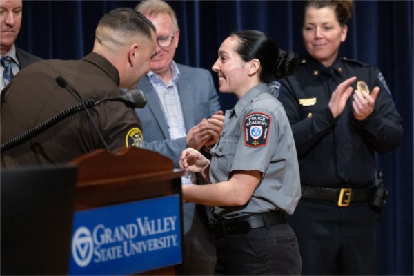 GVSU Police Academy recruits shake hands with leadership during their graduation ceremony.